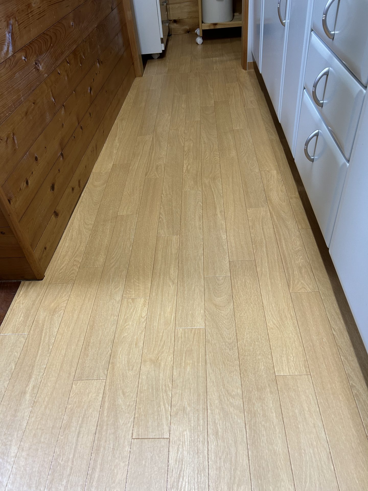 ラグリエのシンプル フロアマット〈木目ライトブラウン〉92cm幅をキッチンに敷いた様子。明るいブラウンが空間をトーンアップし、冬の寒さ対策にもなる仕上がり。