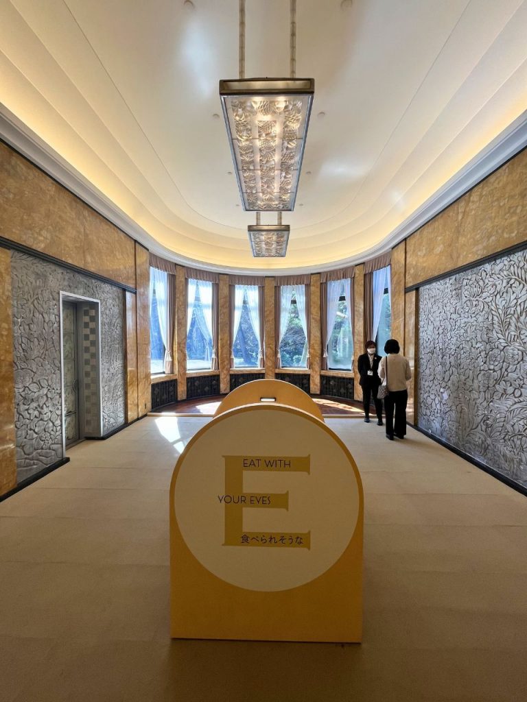 東京都庭園美術館の食堂内部。円形の張り出し窓と装飾レリーフ壁、アール・デコ様式の照明が並ぶ空間。