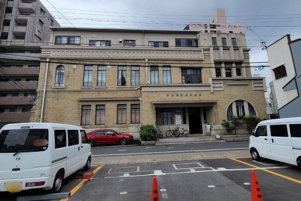 名古屋陶磁器会館の外観。歴史を感じるタイル張りの建物正面と、道路沿いに建つ重厚な近代建築。