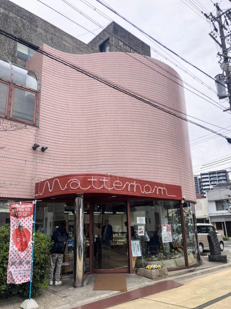 曲線的なピンク色の外壁が印象的なマッターホーン豊橋本店の外観